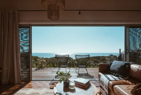 3D illustration mockup photo frame on the wall in living room, scandinavian style interior with cozy furniture and houseplant in natural decoration concept, rendering